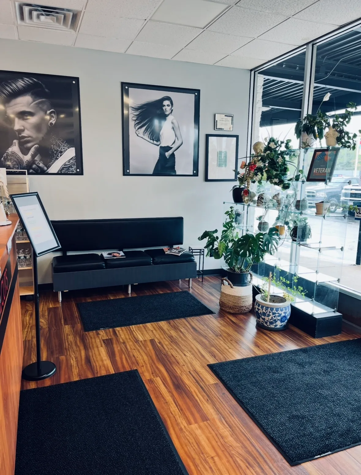 Waiting area with black-and-white portraits and seating