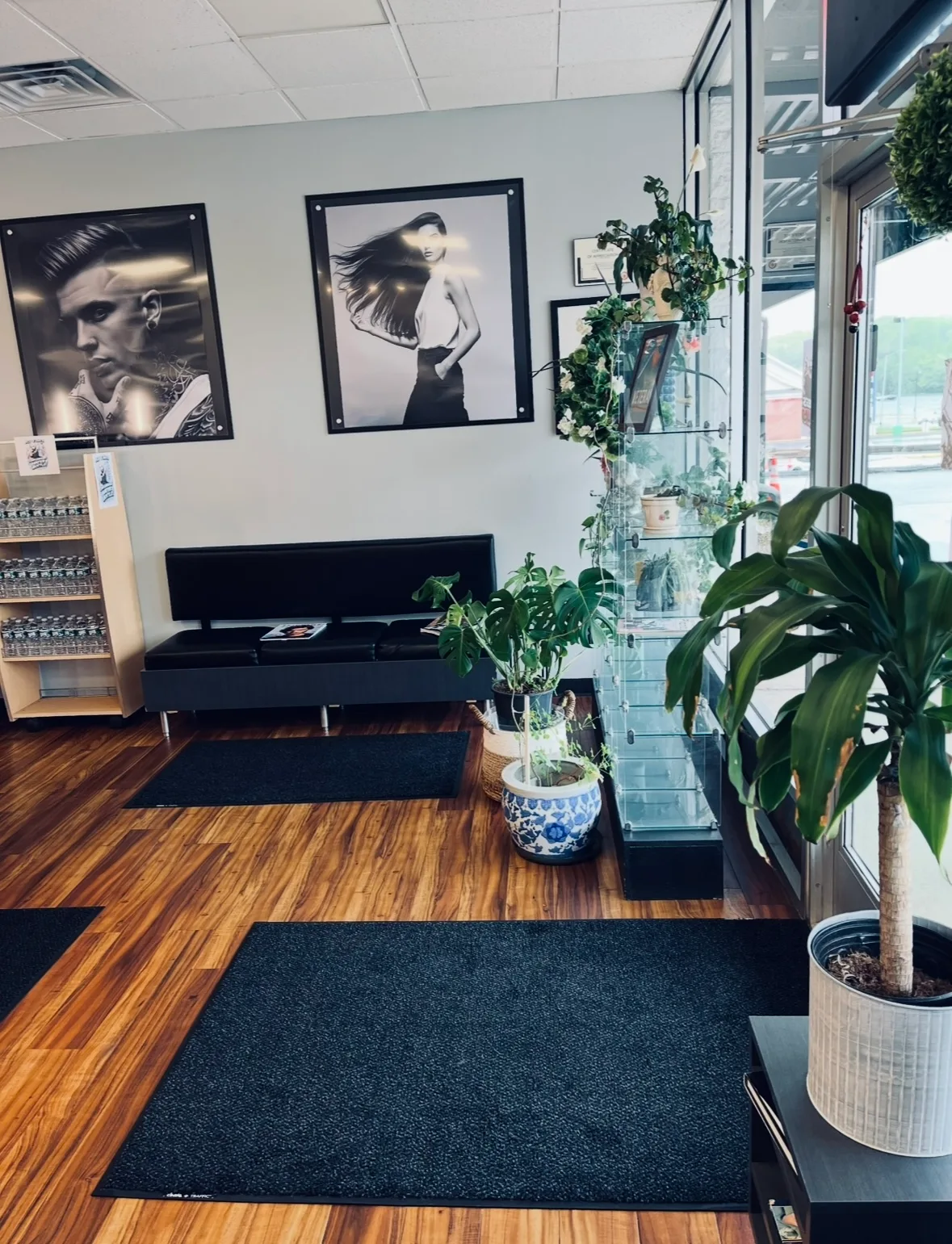 Lobby with framed portraits, plants, and display shelves