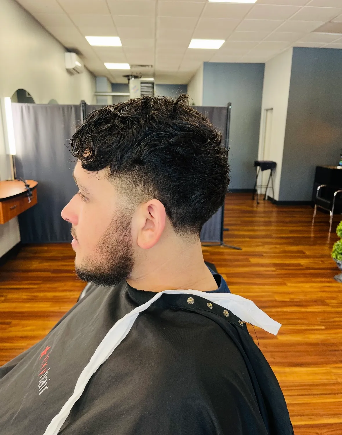 After: a curly top finished with a low fade