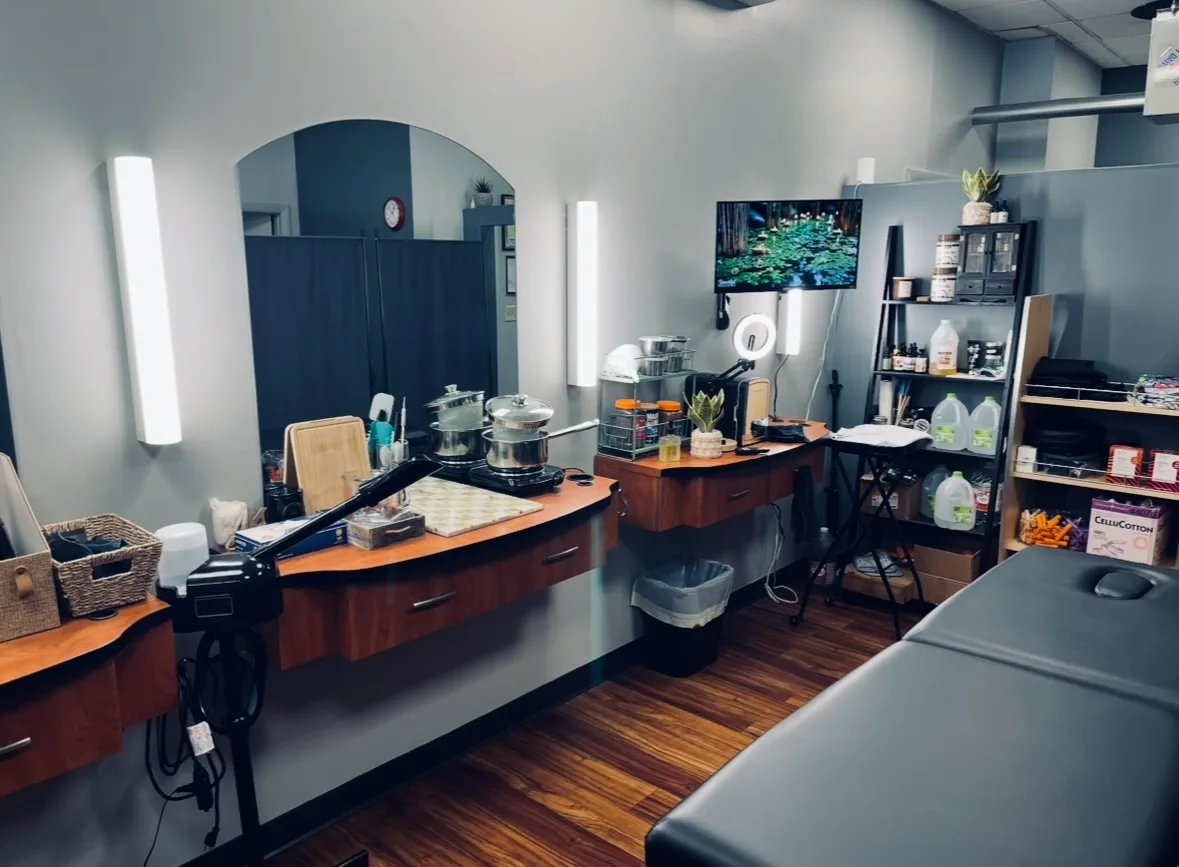Treatment room with vanity, mirror, and supply shelving
